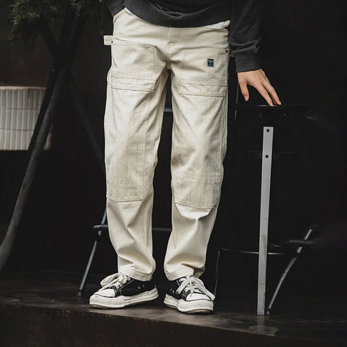Men’s retro workwear off-white distressed loose fit jeans with multiple pockets.